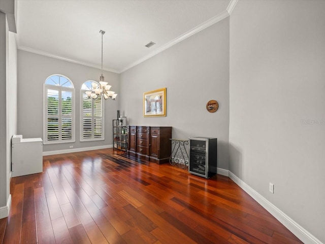 6905 Arabian Rd, Odessa, FL 33556 - unfurnished dining area with a chandelier, hardwood / wood-style flooring, crown molding, and beverage cooler