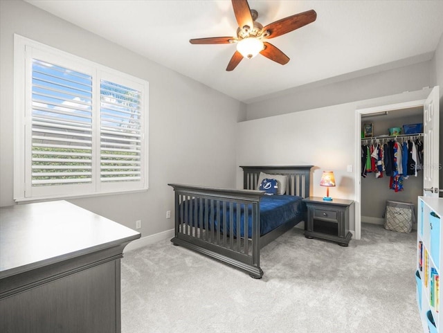 6905 Arabian Rd, Odessa, FL 33556 - bedroom with light carpet, a spacious closet, a closet, and a ceiling fan