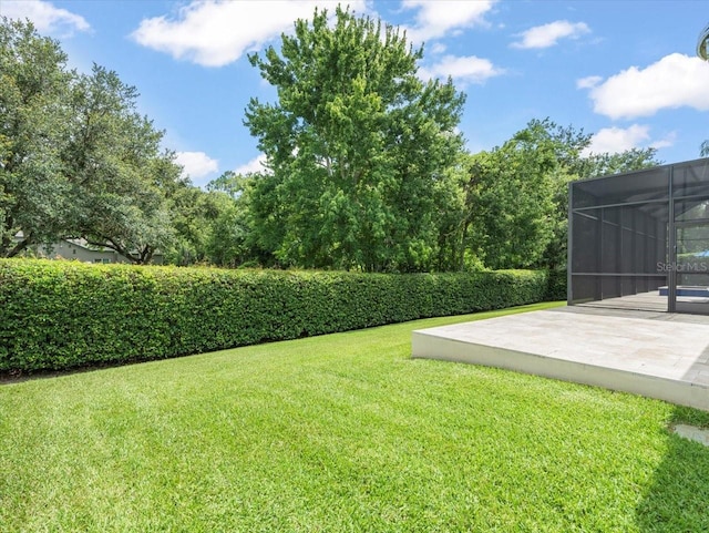 6905 Arabian Rd, Odessa, FL 33556 - view of grassy yard featuring a lanai and a patio area