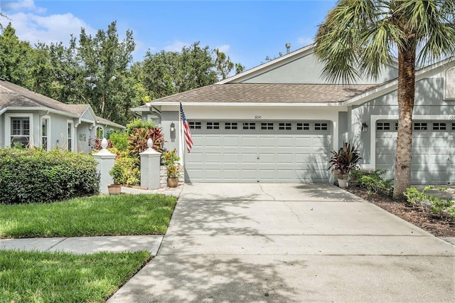 6041 Sandhill Ridge Dr, Lithia, FL 33547 - ranch-style home featuring a garage, concrete driveway, stucco siding, and a shingled roof