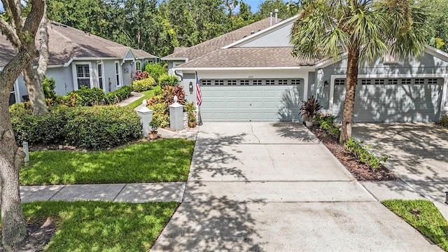 6041 Sandhill Ridge Dr, Lithia, FL 33547 - ranch-style house with an attached garage, concrete driveway, stucco siding, and roof with shingles