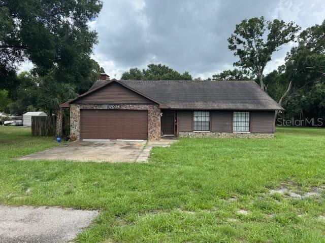 17004 State Road 54, Lutz, FL 33558 - ranch-style home with an attached garage, a front yard, a chimney, and driveway