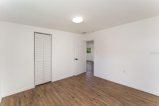 833 N Suwannee Ave, Lakeland, FL 33815 - unfurnished bedroom with wood finished floors and a closet