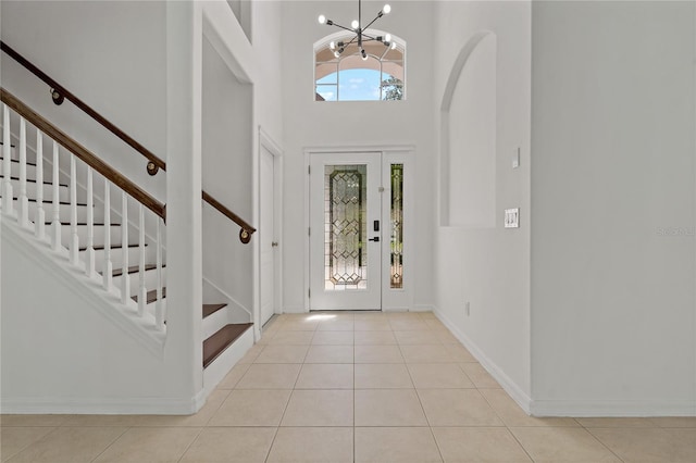 19206 Ivy Oak Way, Tampa, FL 33647 - foyer with a chandelier, stairs, a high ceiling, and tile patterned flooring