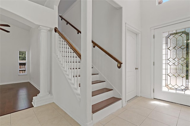 19206 Ivy Oak Way, Tampa, FL 33647 - tiled foyer with decorative columns, stairs, and ceiling fan