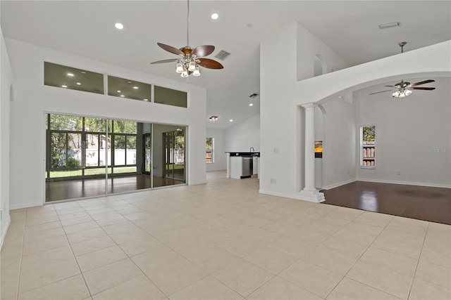 19206 Ivy Oak Way, Tampa, FL 33647 - unfurnished living room featuring ceiling fan, high vaulted ceiling, ornate columns, recessed lighting, and tile patterned flooring