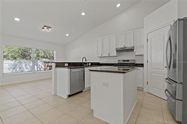 19206 Ivy Oak Way, Tampa, FL 33647 - kitchen featuring stainless steel appliances, under cabinet range hood, a peninsula, light tile patterned floors, and white cabinets