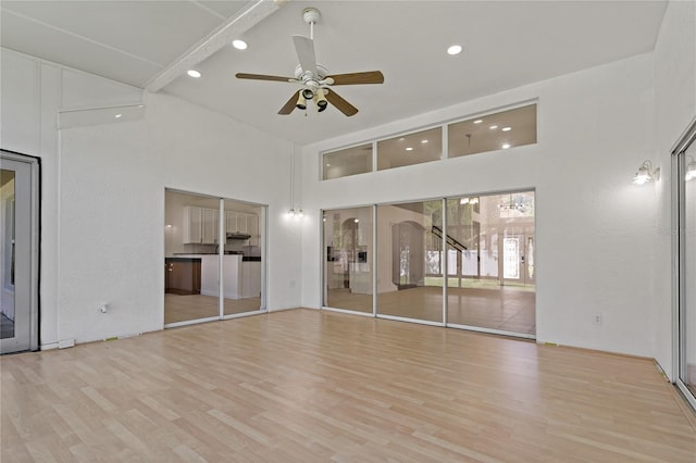 19206 Ivy Oak Way, Tampa, FL 33647 - empty room with a towering ceiling, ceiling fan, recessed lighting, and wood finished floors
