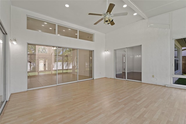 19206 Ivy Oak Way, Tampa, FL 33647 - unfurnished room featuring a towering ceiling, light wood finished floors, recessed lighting, and a ceiling fan