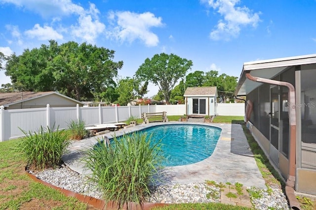 901 Strawberry Ln, Brandon, FL 33511 - view of swimming pool with a sunroom, a fenced backyard, a storage unit, and a patio area