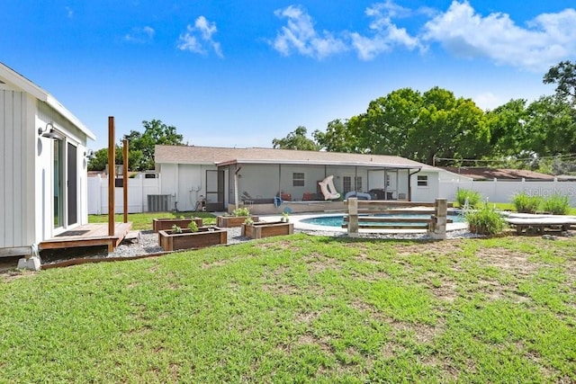 901 Strawberry Ln, Brandon, FL 33511 - back of house featuring a vegetable garden and a fenced backyard