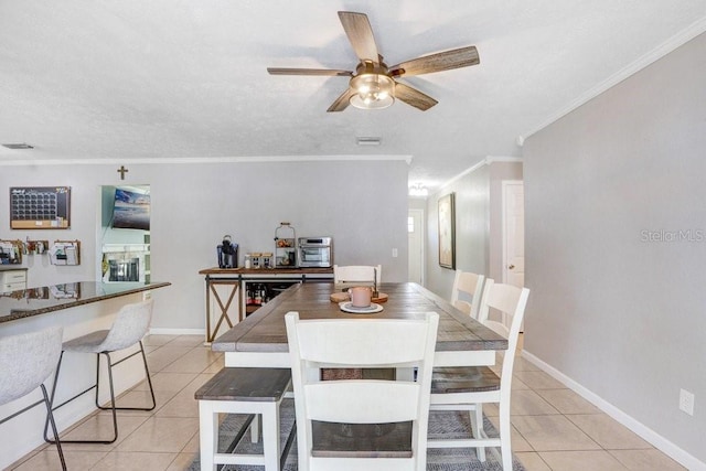 901 Strawberry Ln, Brandon, FL 33511 - dining space with light tile patterned floors, ceiling fan, and crown molding