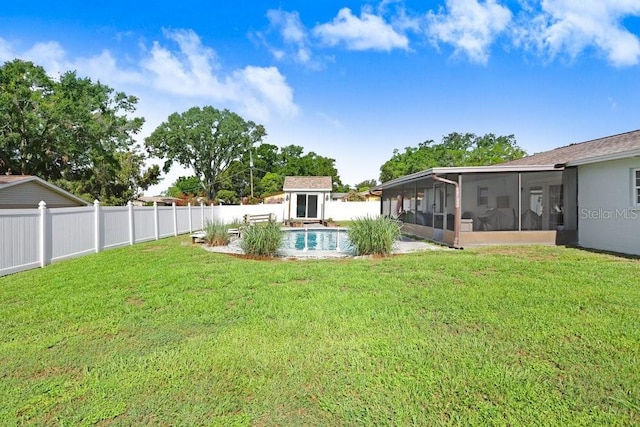 901 Strawberry Ln, Brandon, FL 33511 - fenced backyard with a sunroom and a storage unit