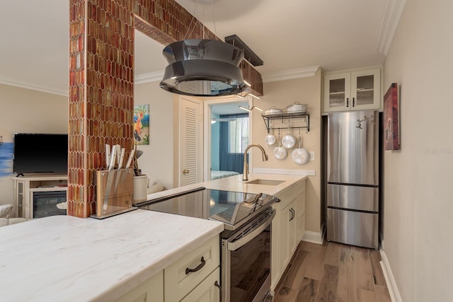 1301 S Howard Ave Unit A9, Tampa, FL 33606 - kitchen with appliances with stainless steel finishes, ornamental molding, wood finished floors, glass insert cabinets, and white cabinetry