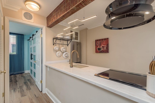 1301 S Howard Ave Unit A9, Tampa, FL 33606 - kitchen featuring black electric cooktop, wood finished floors, and light countertops