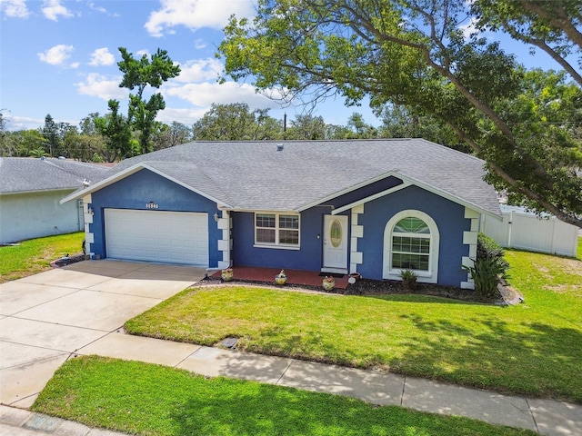 8823 Aruba Ln, Port Richey, FL 34668 - ranch-style home featuring a shingled roof, an attached garage, and stucco siding