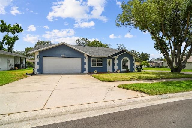 8823 Aruba Ln, Port Richey, FL 34668 - ranch-style house with an attached garage, driveway, a front lawn, and stucco siding