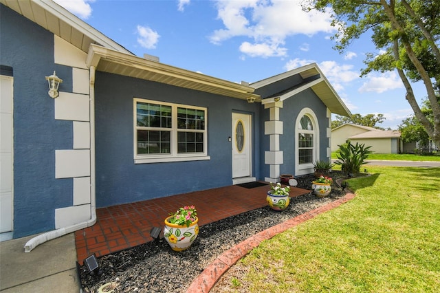 8823 Aruba Ln, Port Richey, FL 34668 - view of front of home with a front lawn, stucco siding, and brick siding