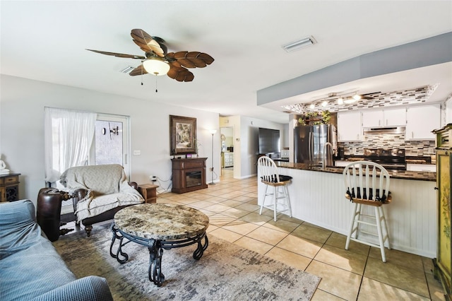 8823 Aruba Ln, Port Richey, FL 34668 - living area featuring light tile patterned flooring and ceiling fan