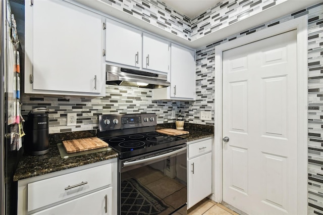 8823 Aruba Ln, Port Richey, FL 34668 - kitchen with stainless steel electric range, under cabinet range hood, backsplash, and white cabinets