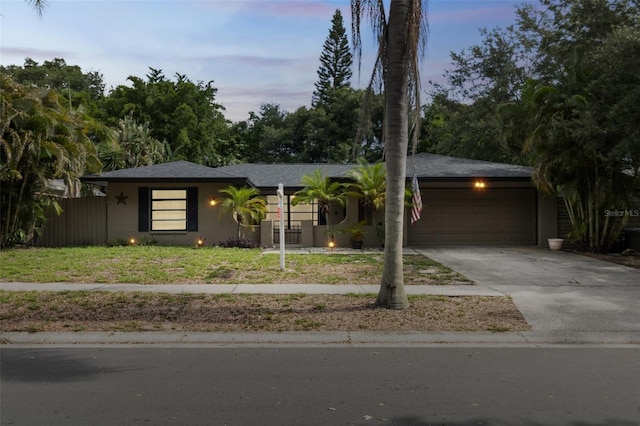 2199 Blue Tern Dr, Palm Harbor, FL 34683 - ranch-style home with an attached garage, stucco siding, and asphalt driveway