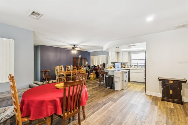 2199 Blue Tern Dr, Palm Harbor, FL 34683 - dining room featuring ceiling fan and light wood-type flooring