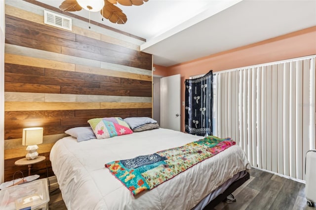 2199 Blue Tern Dr, Palm Harbor, FL 34683 - bedroom with wooden walls, wood finished floors, and ceiling fan