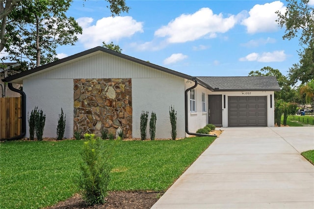 1707 Solon Ave, Dunedin, FL 34698 - view of front of home with driveway, an attached garage, stone siding, and stucco siding