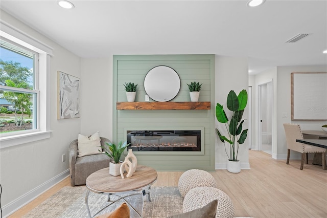 1707 Solon Ave, Dunedin, FL 34698 - living room with wood finished floors, a glass covered fireplace, and recessed lighting
