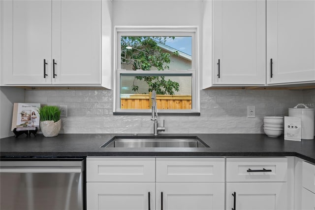 1707 Solon Ave, Dunedin, FL 34698 - kitchen with stainless steel dishwasher, white cabinetry, dark countertops, and tasteful backsplash