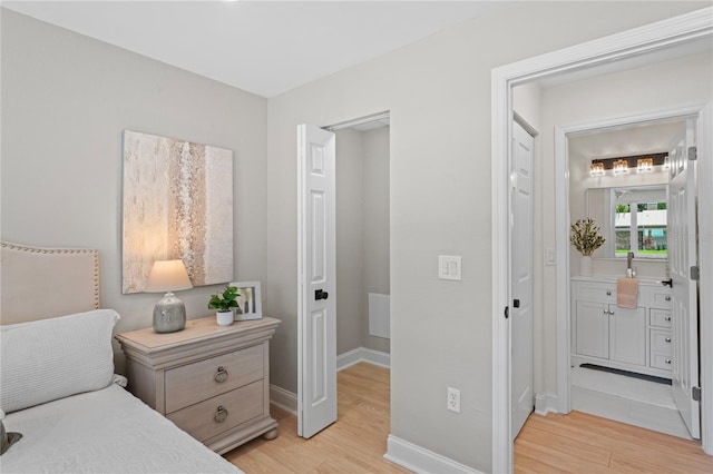1707 Solon Ave, Dunedin, FL 34698 - bedroom featuring light wood finished floors and connected bathroom