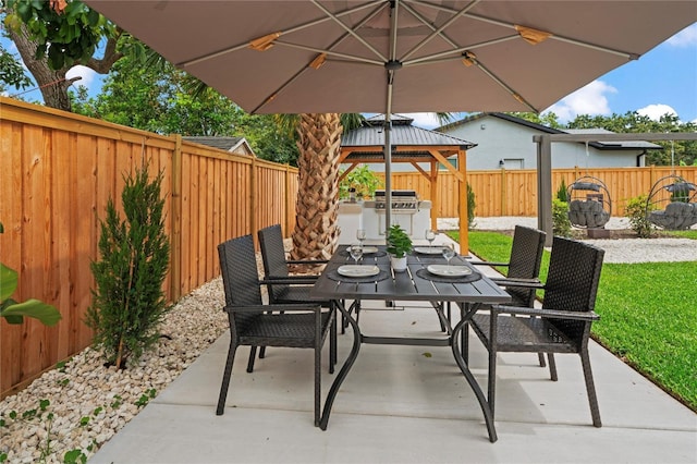 1707 Solon Ave, Dunedin, FL 34698 - fenced backyard with outdoor dining space, a patio area, exterior kitchen, and a gazebo