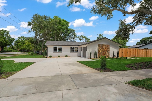 1707 Solon Ave, Dunedin, FL 34698 - ranch-style home with concrete driveway, stucco siding, an attached garage, and stone siding