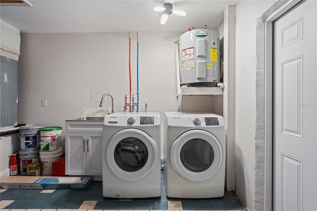 1707 Solon Ave, Dunedin, FL 34698 - laundry area featuring electric water heater, separate washer and dryer, tile patterned floors, and cabinet space