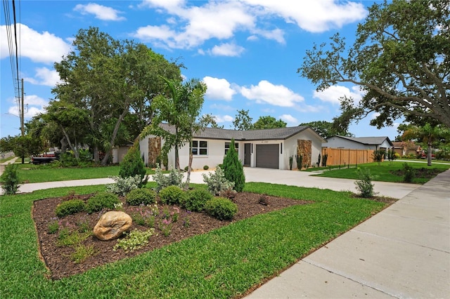 1707 Solon Ave, Dunedin, FL 34698 - view of front of home with an attached garage, driveway, and stucco siding