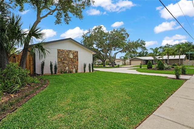 1707 Solon Ave, Dunedin, FL 34698 - view of grassy yard with concrete driveway and a garage