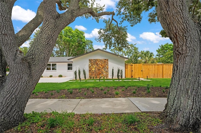 1707 Solon Ave, Dunedin, FL 34698 - view of front of house featuring stone siding, a gate, and stucco siding