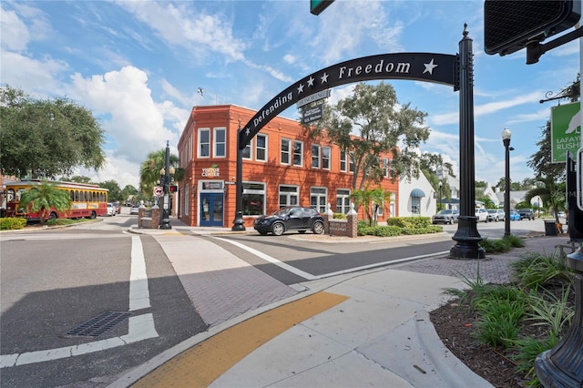 1707 Solon Ave, Dunedin, FL 34698 - view of asphalt street with curbs, street lights, sidewalks, and traffic signs