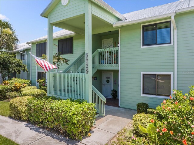 5725 Pelican Pointe Dr Unit 1, Sebastian, FL 32958 - view of front facade featuring stairway