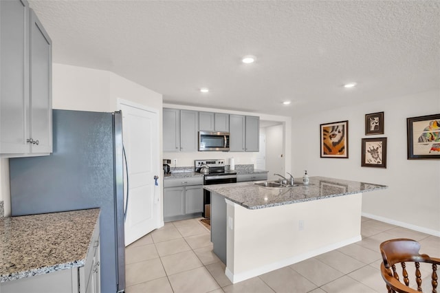 7774 Sail Clover Ln, Zephyrhills, FL 33540 - kitchen with appliances with stainless steel finishes, gray cabinetry, light tile patterned flooring, a textured ceiling, and recessed lighting