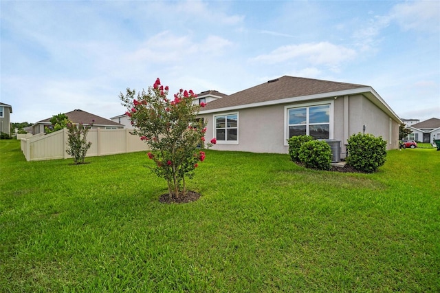 7774 Sail Clover Ln, Zephyrhills, FL 33540 - rear view of property featuring stucco siding and a shingled roof