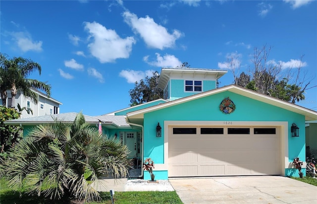 1626 Sea Breeze Dr, Tarpon Springs, FL 34689 - view of front facade with a garage, driveway, and stucco siding