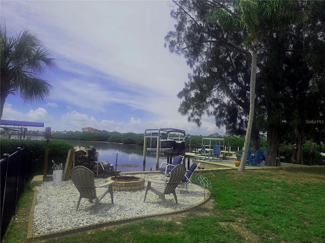 1626 Sea Breeze Dr, Tarpon Springs, FL 34689 - view of green lawn with an outdoor fire pit, a water view, and a dock