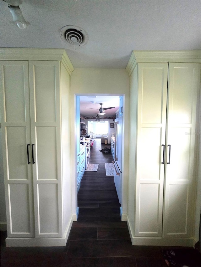 1626 Sea Breeze Dr, Tarpon Springs, FL 34689 - hallway with dark wood-style floors and baseboards