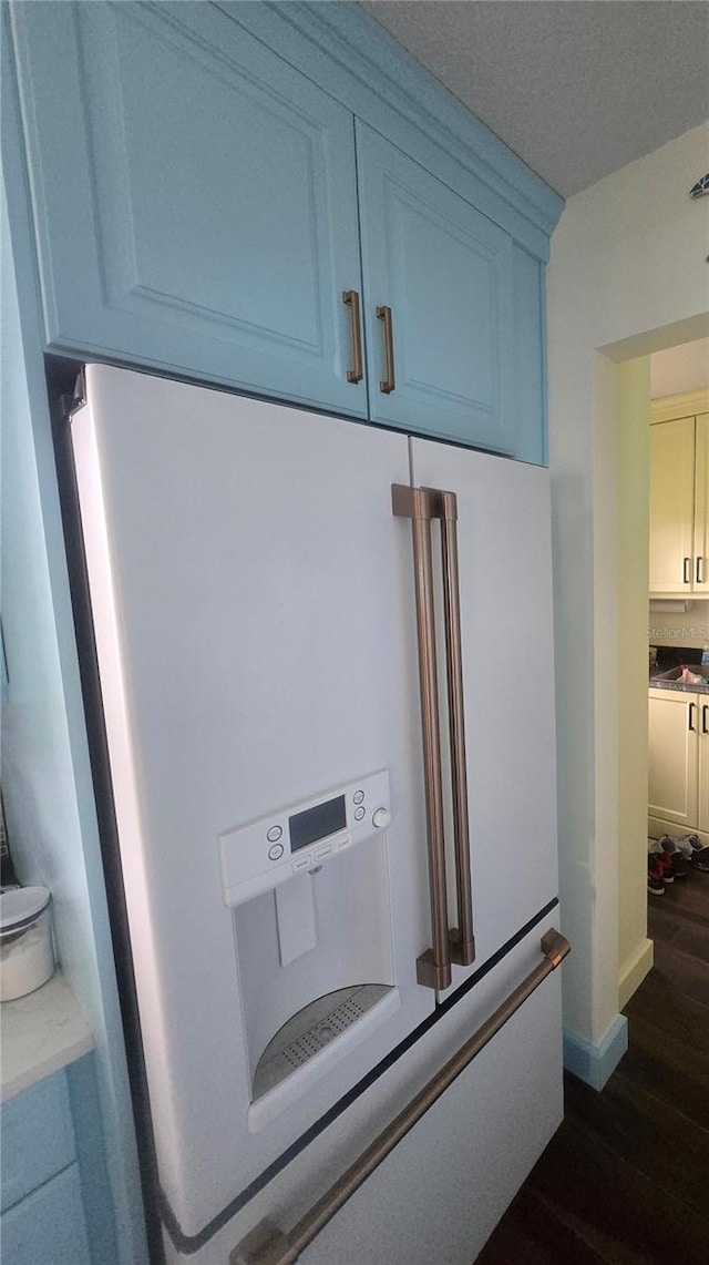 1626 Sea Breeze Dr, Tarpon Springs, FL 34689 - kitchen view of white refrigerator with ice dispenser, dark wood-style floors, and light countertops
