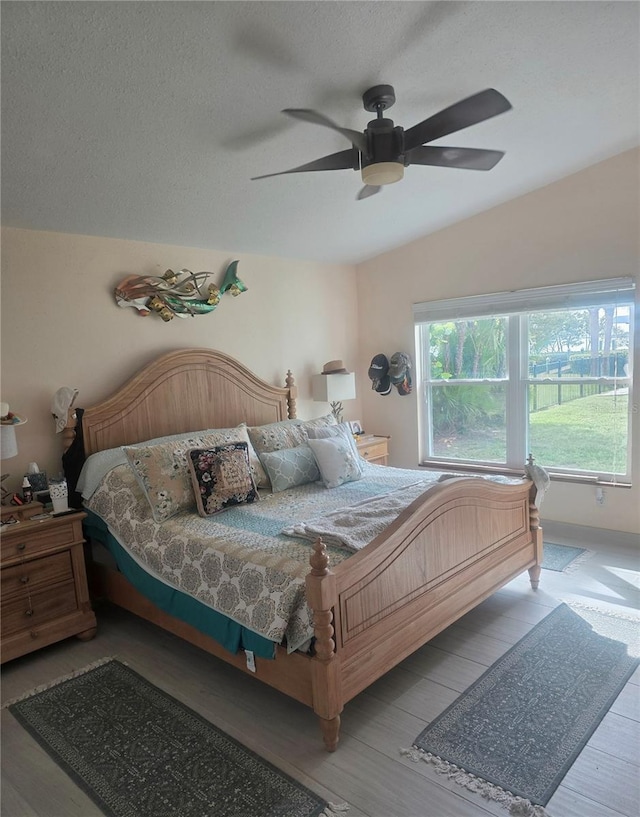 1626 Sea Breeze Dr, Tarpon Springs, FL 34689 - bedroom with wood finished floors, a ceiling fan, and a textured ceiling