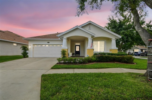 18203 Tivoli Ln, Lutz, FL 33558 - view of front of house featuring stucco siding, driveway, an attached garage, and a lawn