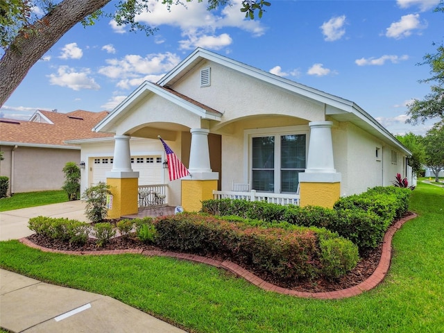 18203 Tivoli Ln, Lutz, FL 33558 - view of front of home with stucco siding, covered porch, concrete driveway, a garage, and a front yard