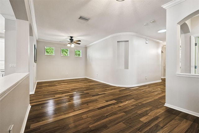 18203 Tivoli Ln, Lutz, FL 33558 - empty room with a ceiling fan, arched walkways, dark wood finished floors, and crown molding