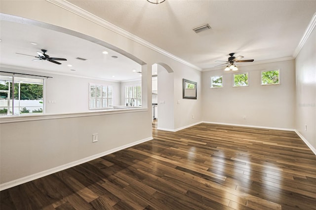 18203 Tivoli Ln, Lutz, FL 33558 - empty room with a ceiling fan, arched walkways, hardwood / wood-style floors, healthy amount of natural light, and ornamental molding
